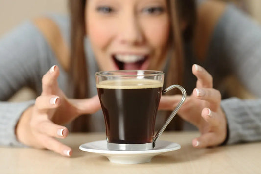 An extremely happy person enjoying a cup of mushroom coffee.